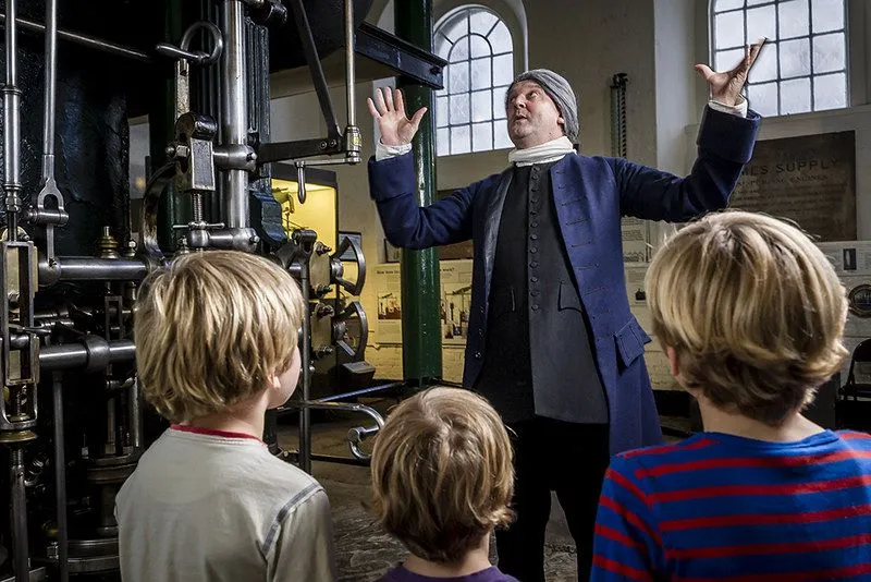 kids at the museum Water and Steam listening to a man telling stories