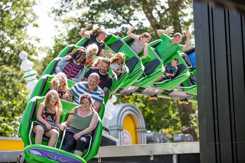 parents with their kids at a roller coster