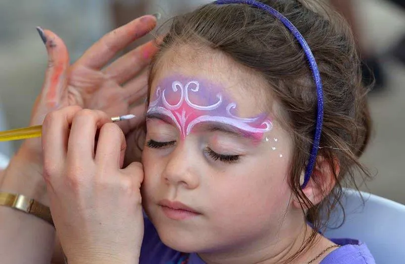 little girl getting her face painted