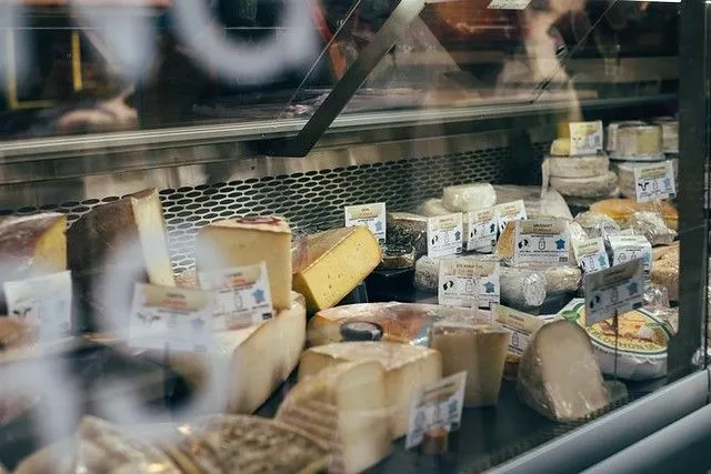 a wide selection of cheeses at a shop