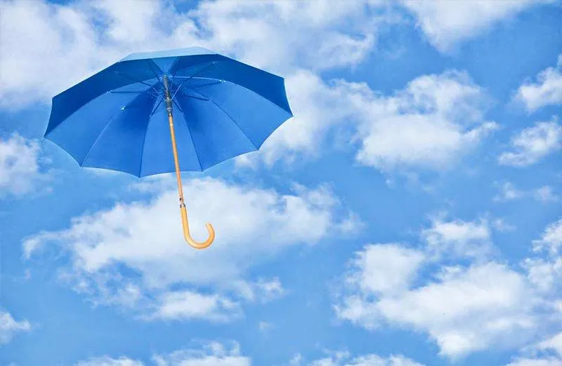 a blue umbrella in the sky