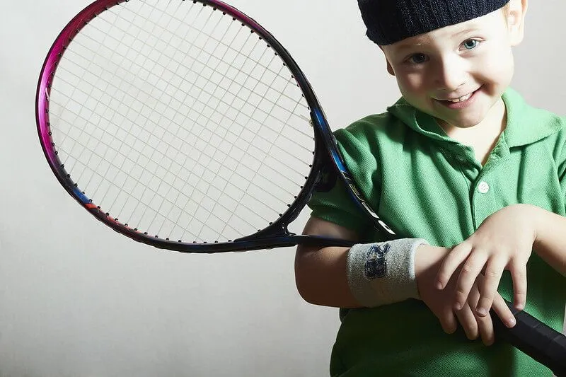 kid playing tennis