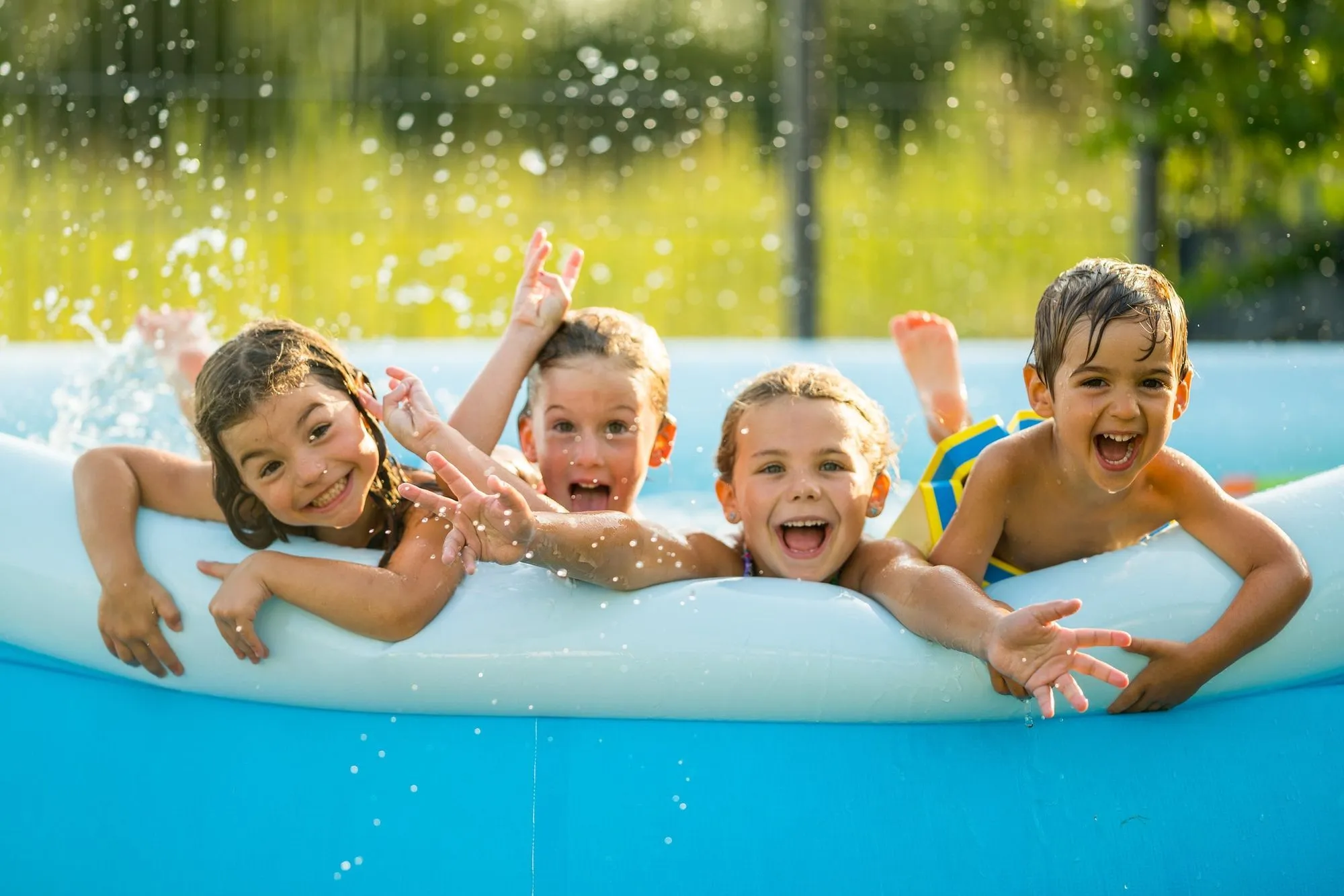 group of children splashing in paddling pool