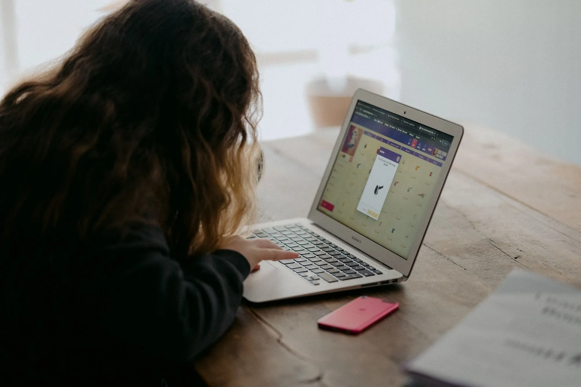 child practising coding on laptop