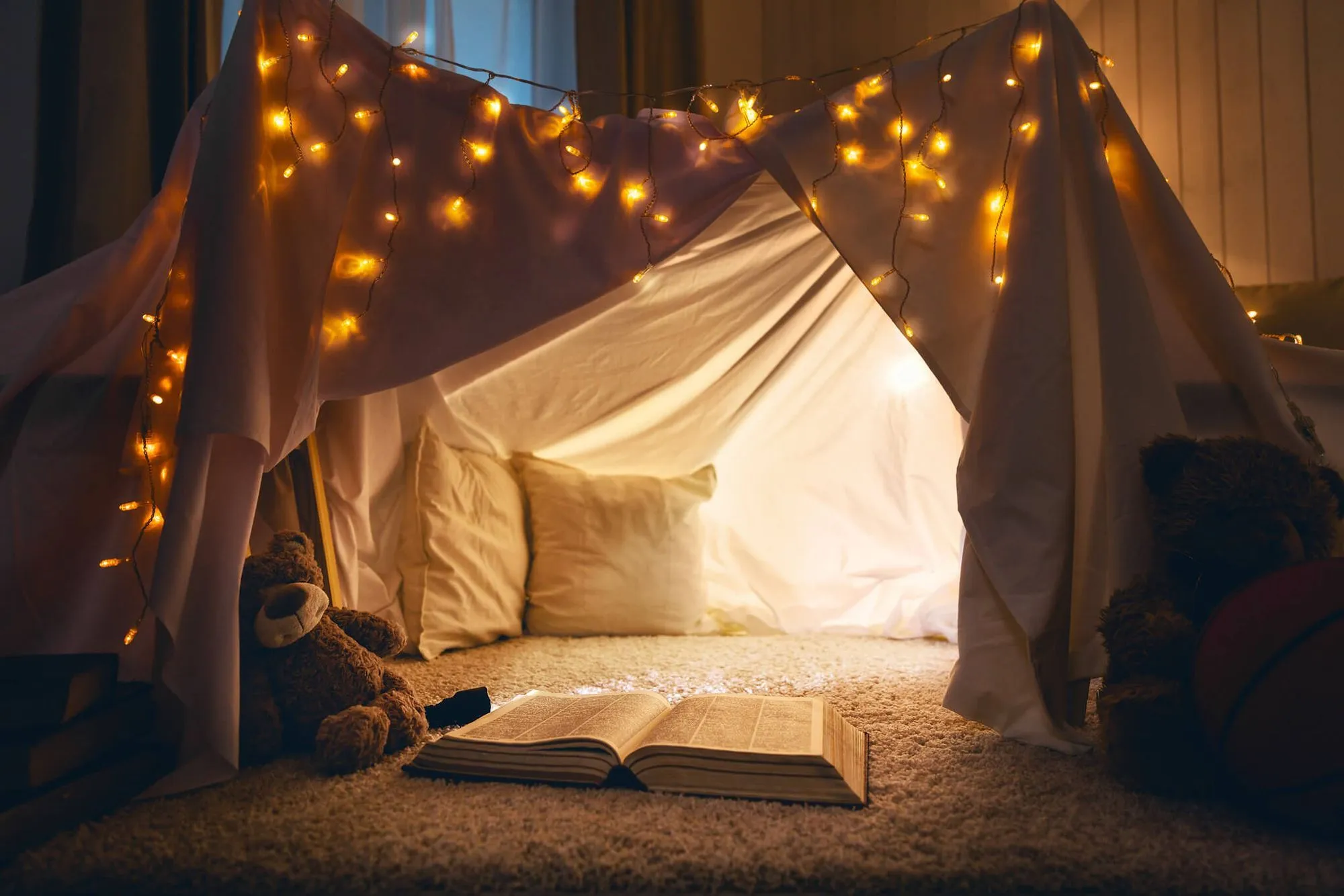 Set up a reading den in your living room, complete with fairy lights and cosy blankets.