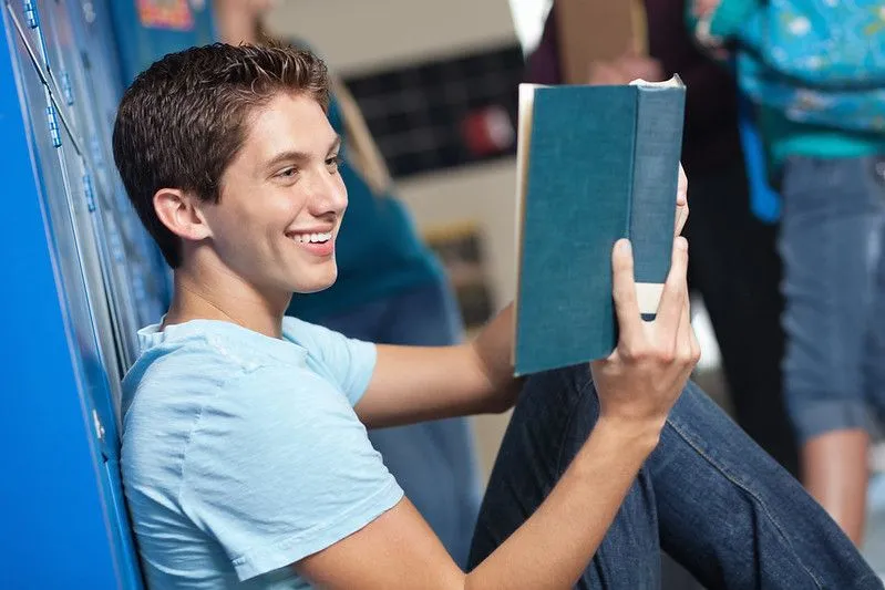 Teenage boy reading an autobiography.