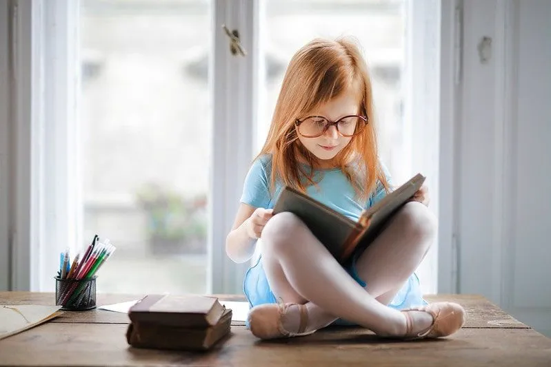 Pre-school girl reading a book from the Oxford Reading Tree