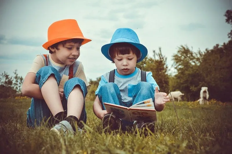 Two pre-school boys reading books as part of the Oxford Reading Tree