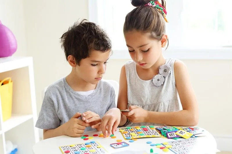 Siblings working out grid method multiplication