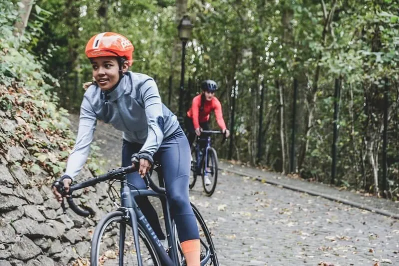 cyclists wearing helmets in a forest