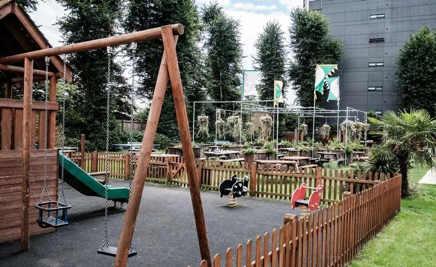 Outdoor seating and play area at The Drayton Court pub.