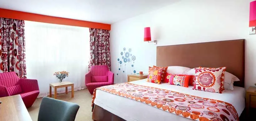 Colourful bedroom decor at family friendly Bedruthan Hotel and Spa in Cornwall.