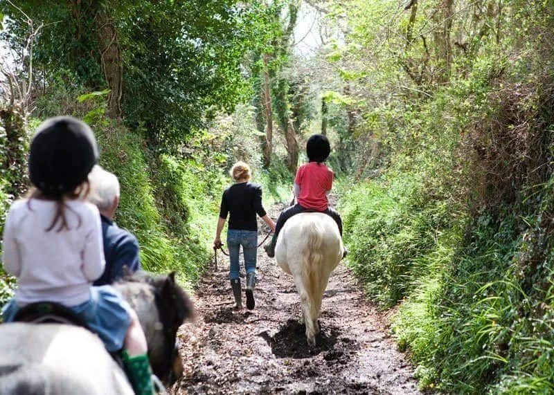 Kids going horse-riding during stay at Bosinver in Cornwall. 