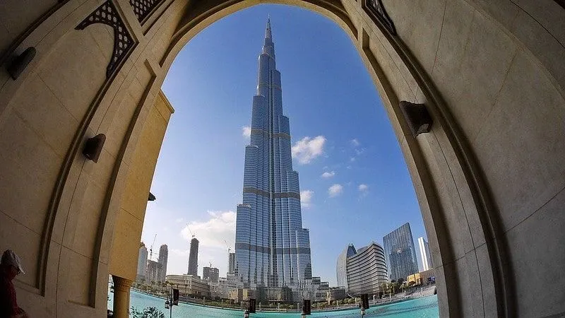 View of the Burj Khalifa in Dubai framed by an arch. 