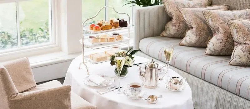 Elegant afternoon tea with fancy decor and place settings.