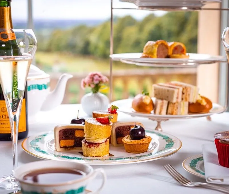 Afternoon tea with bubbles and a garden view.