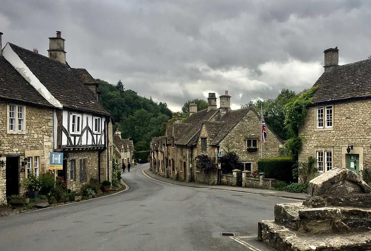 Houses in a Tudor village on a grey, cloudy day.