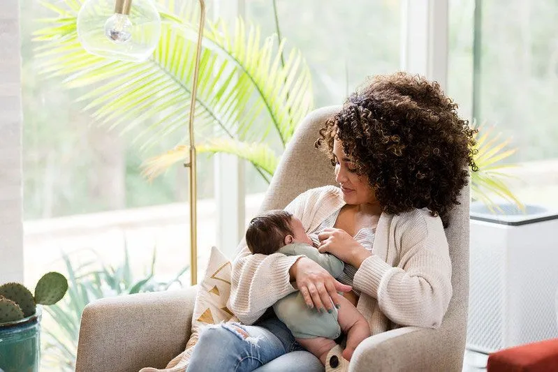 Newborn being nursed in a chair