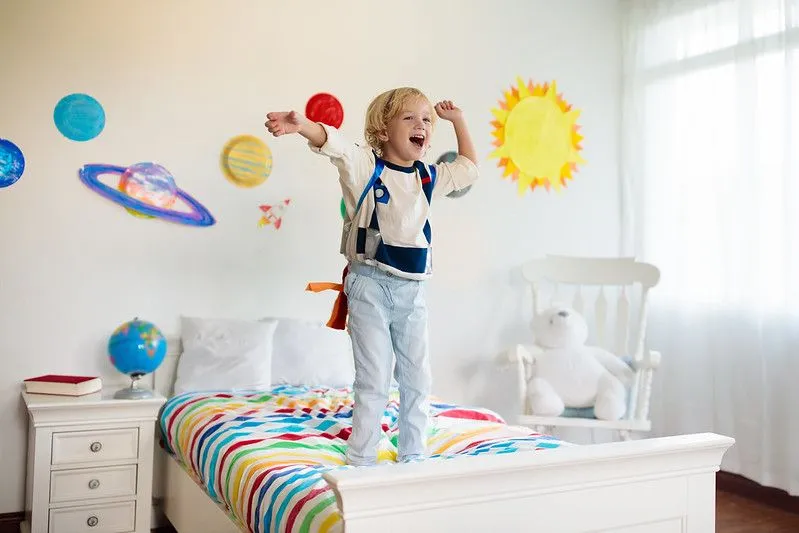 Boy in astronaut with space bedroom.