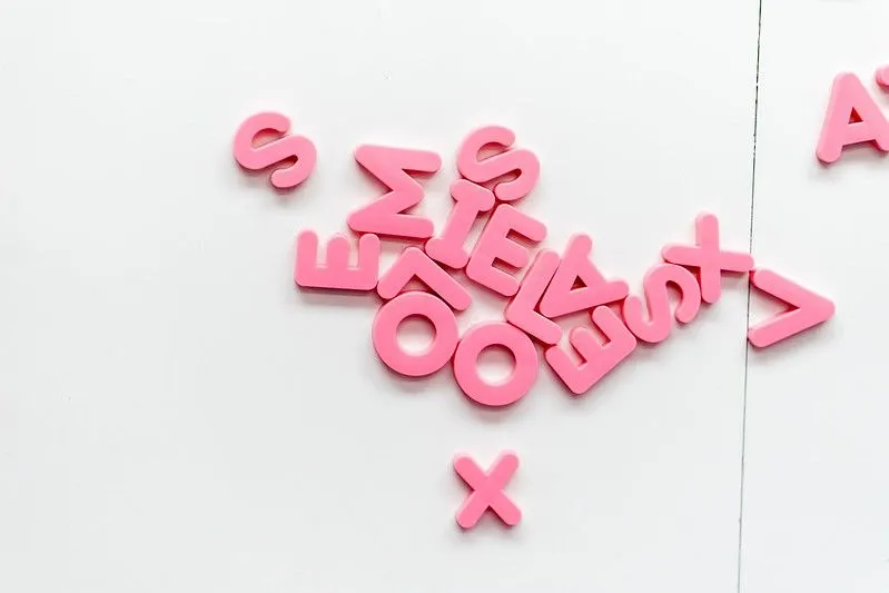 Pink letters creating puns on a white background.