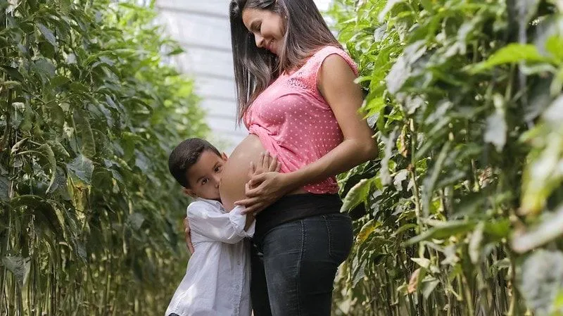 Mum to be, with child, in maternity trousers. 