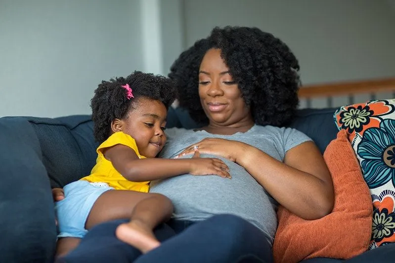 Mum with child in maternity top. 