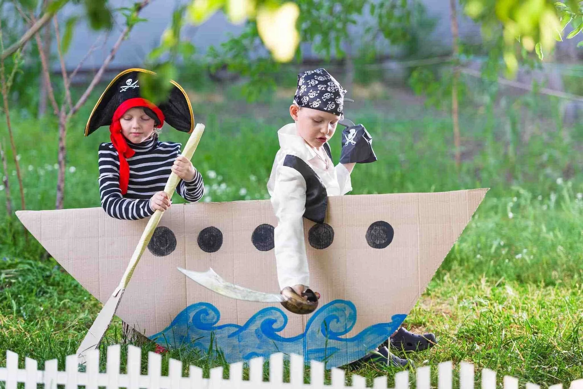 Two boys playing in makeshift pirate ship.