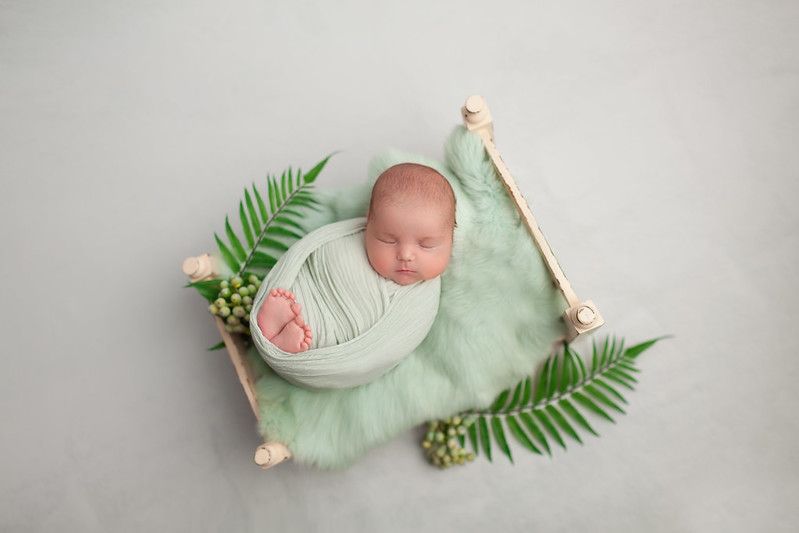 A newborn baby asleep on a tiny bed - Nicknames