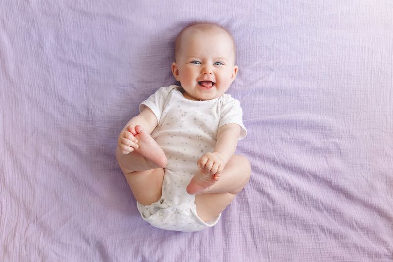 Newborn baby on purple sheet smiling - Nicknames