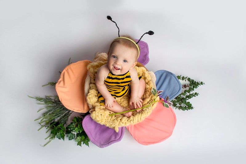Baby boy in bee costume sitting in a giant flower - Nicknames