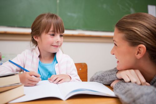 Year 2 girl being tutored in Year 2 spelling words.