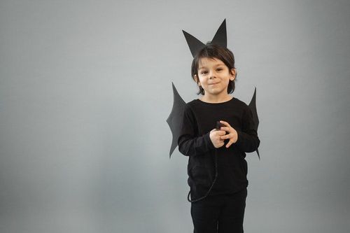 A boy dressed in bat costume