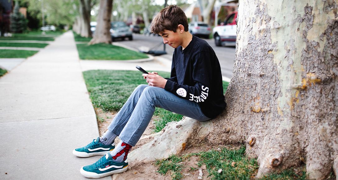 A teenage boy loves his Troomi phone.